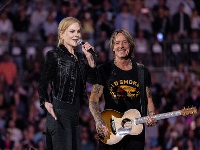 Nicole Kidman (L) appears onstage with her husband Keith Urban