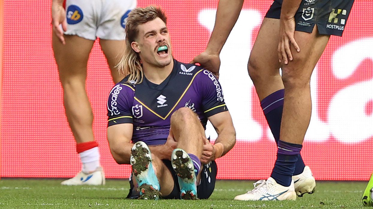 Ryan Papenhuyzen of the Storm is injured after scoring a try against the Dragons.