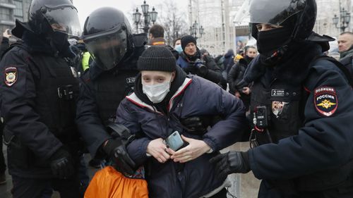 Police detain a protester during a protest against the jailing of opposition leader Alexei Navalny in Moscow, Russia, Saturday, Jan. 23, 2021