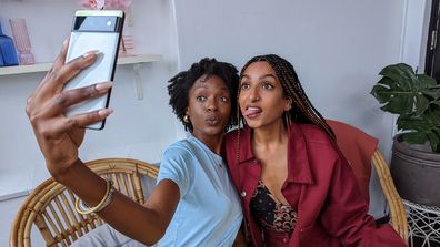 Two women pose for a selfie