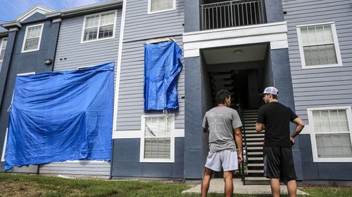 Residents at Westbrook Apartments get a first look at their building where a gunman held four children hostage before taking their life and his own. (AAP)