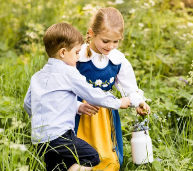 The siblings were photographed collecting wild flowers.