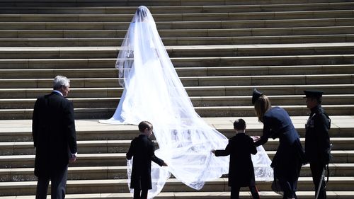 Ms Markle's veil is held in place by Queen Mary's diamond bandeau tiara, lent to her by The Queen. Picture: PA