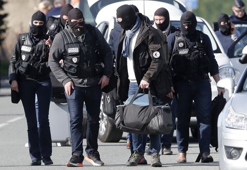 Tactical police clad in balaclavas riot gear were deployed during the tense standoff in the supermarket. (AAP)