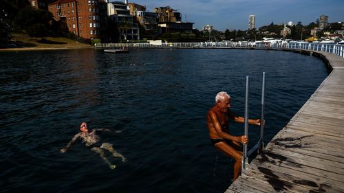 People brave the early morning ahead of the record-breaking heat at Rose Bay's Redleaf Pool in Sydney.