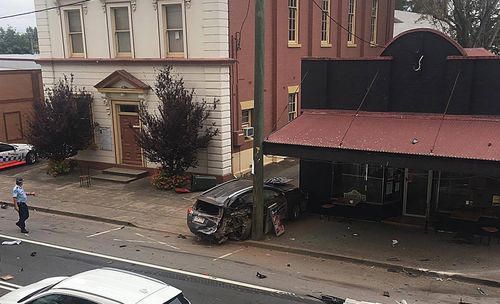 One of the cars was pushed into the cafe across the road from the pub. (AAP)