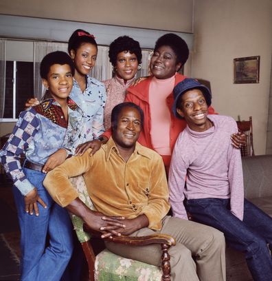 Good Times cast members (left to right) Raplh Carter (as Michael Evans);  BernNadette Stanis (as Thelma Evans Anderson);  Ja'net DuBois (as Willona Woods);  John Amos (as James Evans);  Esther Rolle (as Florida Evans)  and Jimmie Walker (as James Evans, Jr. / J.J.). 1975. Copyright CBS Worldwide Inc. All Rights Reserved. Credit: CBS Photo Archive.