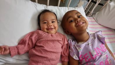 Fiapule in hospital with her baby sister during treatment.