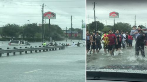 A human chain pulls an elderly man from a flooded SUV. (Stephanie Edward Mata)