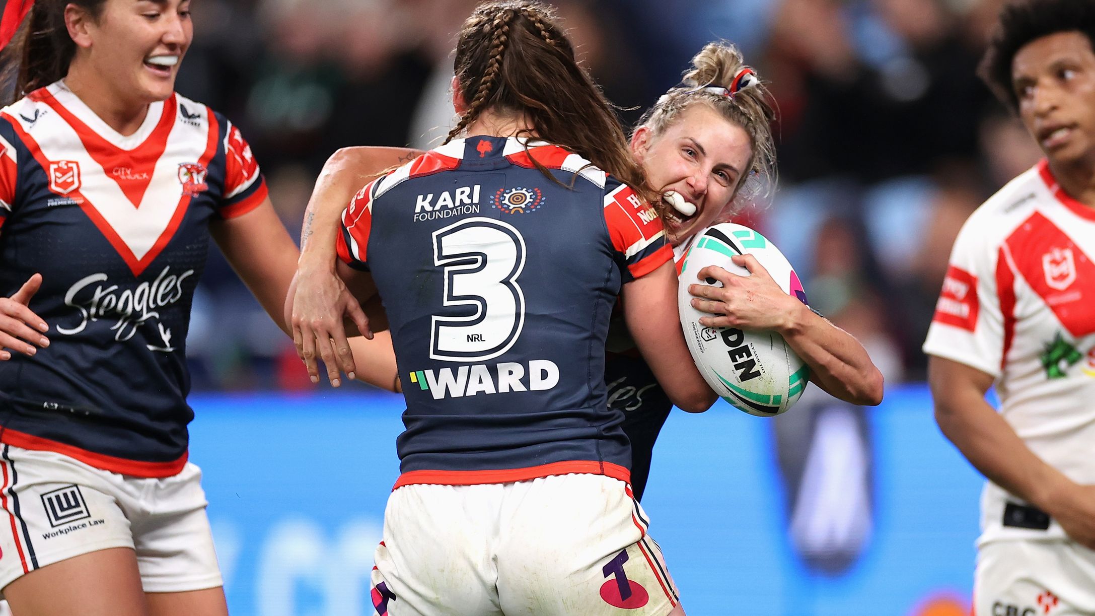 Sam Bremner of the Roosters celebrates scoring a try with Jessica Sergis.