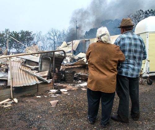Property owners Jim and Lorraine inspect their destroyed house near Roseworthy in the mid-north of South Australia. (AAP) 