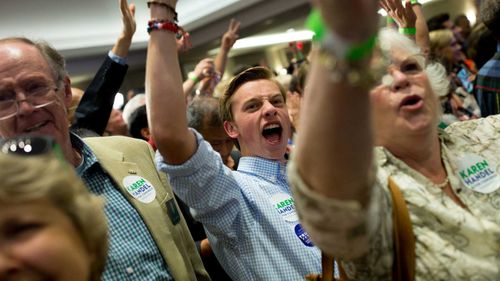 Karen Handel supporters cheer as her victory is announced. (AAP)