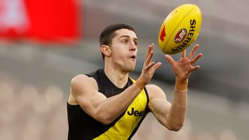 Jason Castagna of the Tigers marks the ball.