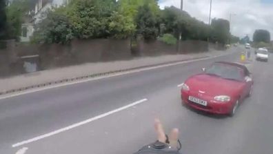 Cyclist gets knocked onto floating mattress (Gallery)