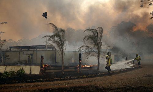 Fire crews save a house in Possum Brush near Taree.