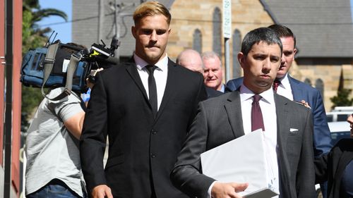 Jack De Belin (middle) has been charged with aggravated sexual assault but has pleaded not guilty.