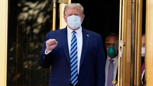 President Donald Trump walks out of Walter Reed National Military Medical Center to return to the White House after receiving treatments for COVID-19