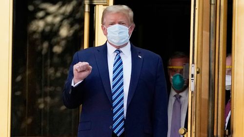 President Donald Trump walks out of Walter Reed National Military Medical Centre to return to the White House.