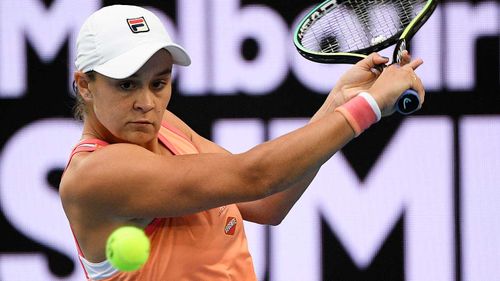 Australia's Ash Barty makes a backhand return to Romania's Ana Bogdan.