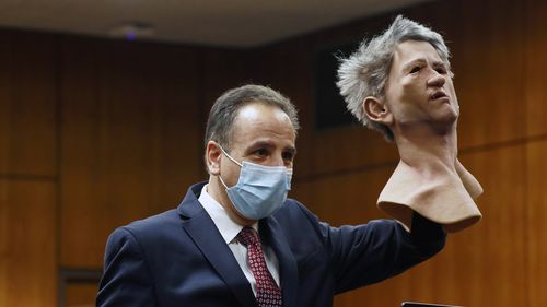 Deputy District Attorney Habib Balian held a rubber latex mask, worn by Robert Durst when police arrested him. 