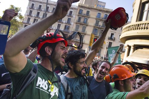 People shout slogans as they demonstrate at University square, in downtown Barcelona. (AAP)