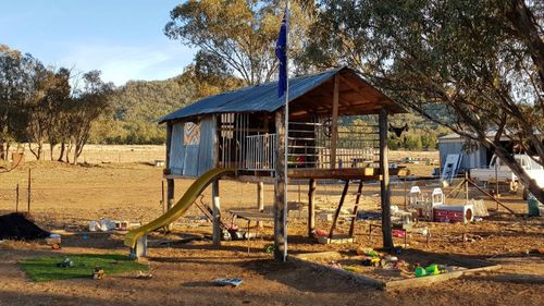 The Taylor family's treehouse, with a patch of fake grass to add some greenery to the dusty scene. (Photo: Jess Taylor)