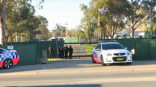 Police at the Gypsy Jokers clubhouse yesterday.