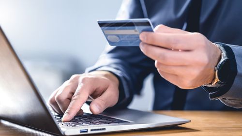 An alleged online scammer has been charged by Victoria police after evading authorities for over ten years.