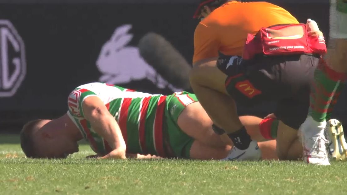 Lachlan Ilias lies on the ground after breaking his leg.