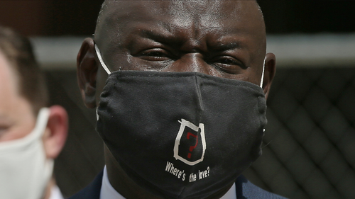 Civil rights attorney Ben Crump wears a face mask with the words "Where's the love?" after announcing Wednesday, July 15, 2020 in Minneapolis the filing of a civil lawsuit against the city of Minneapolis and the officers involved in the death of George Floyd. Floyd died at the hands of police during an arrest on Memorial Day. (AP Photo/Jim Mone)