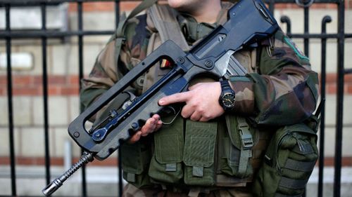 A French soldier stands guard outside a Jewish school in Paris following recent terror attacks. (AAP)
