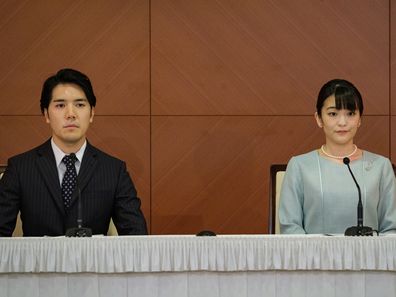 TOKYO, JAPAN - OCTOBER 26: Princess Mako (R), the elder daughter of Prince Akishino and Princess Kiko, and her husband Kei Komuro, a university friend of Princess Mako, pose during a press conference to announce their wedding at Grand Arc Hotel on October 26, 2021 in Tokyo, Japan. Princess Mako married Kei Komuro today at a registry office following a relationship beset with controversy following the revelation that Mr Komuros mother was embroiled in a financial dispute with a former fiancé. Fol