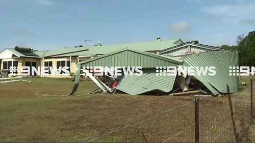 Daylight revealed the roof had been torn of the residence. (9NEWS)
