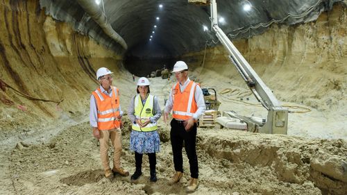 Transport Minister for NSW Rodd Staples (right), NSW Premier Gladys Berejiklian (center), and Transport and Infrastructure MP for NSW Andrew Constance are seen beneath Barangaroo where construction of the Barangaroo Metro is taking place in Sydney, Thursday, March 21, 2019.