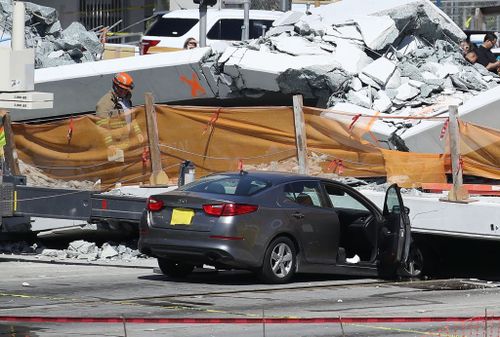 Authorities have confirmed eight cars are trapped beneath the rubble of the bridge. (Getty)