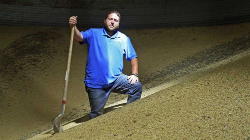 Soybean farmer Michael Petefish stands inside a bin with soybeans from last season's crop at his farm near Claremont in southern Minnesota. (AP)