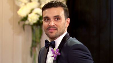 Michael turns to meet his new bride. 