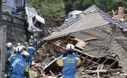 The desperate race to find survivors has begun after heavy rains caused landslides in south-western Japan. Picture: AP
