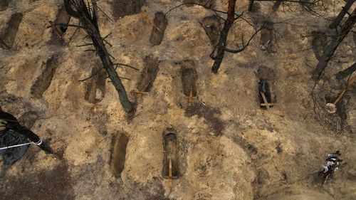 In an aerial view, unidentified makeshift graves are seen at the Pishanske cemetery on September 23, 2022 in Izium, Ukraine. A total of 447 bodies was exhumed from the gravesite, including 22 soldiers and 5 children, and the bodies will be examined by forensic officials for possible war crimes. In recent weeks, Ukrainian forces have reclaimed villages east and south of Kharkiv, as Russian forces have withdrawn from areas they've occupied since early in the war.  (P