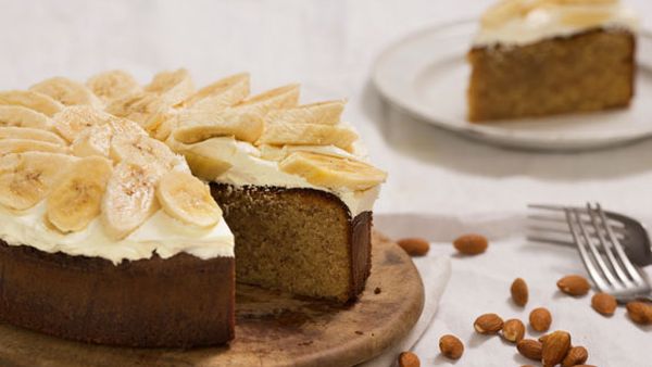 Flourless white chocolate and orange blossom almond cake with buttercream and banana