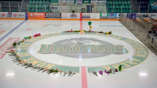 Flowers are shown at centre of the ice rink as preparations are made at Elgar Petersen Arena for a vigil  in Humboldt, Saskatchewan. (AP).