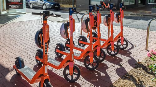 Adelaide, South Australia - April 4, 2021: Neuron E-scooters parked in Adelaide city centre ready to ride on a bright day