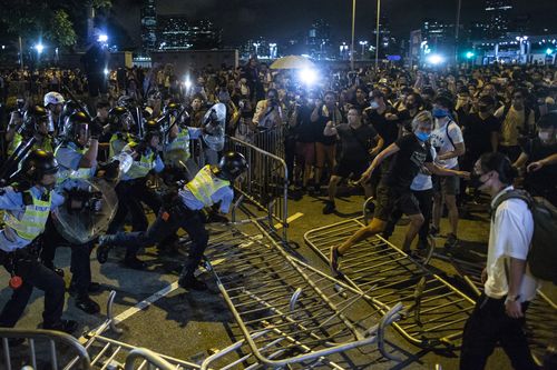 Riot police officers seen clashing with protesters after the huge demonstration against the extradition bill. 