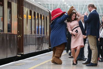 The Duke of Cambridge watches as his wife the Duchess of Cambridge dances with a costumed figure of Paddington bear on platform 1 at Paddington Station, London, as they attend the Charities Forum event, joining children from the charities they support and meeting the cast and crew from the forthcoming film Paddington 2. PRESS ASSOCIATION Photo. Picture date: Monday October 16, 2017. See PA story ROYAL Paddington. Photo credit should read: Jonathan Brady/PA Wire