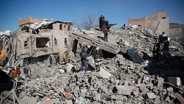 People inspect the wreckage of buildings that were damaged by Saudi-led coalition airstrikes, in Sanaa, Yemen.
