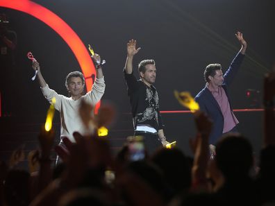 Actor Hugh Jackman, right, Ryan Reynolds and director Shawn Levy, left, wave during the red carpet event to promote their latest movie "Deadpool & Wolverine" in Seoul, South Korea, Thursday, July 4, 2024. 