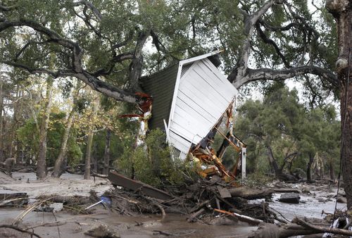 A structure is smashed against a tree along Hot Springs Road in Montecito. (AAP)