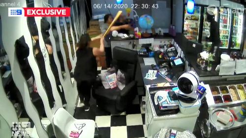 The shop's owner told his wife to grab a pair of scissors and a baseball bat from under the counter.