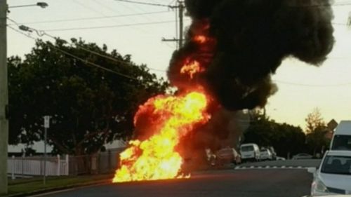 Flames and black smoke furiously billowed from the ignited police car. (9NEWS)