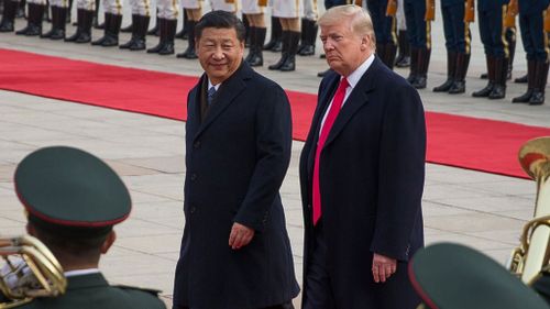 US President Donald Trump and Chinese President Xi Jinping review soldiers in China during a welcome ceremony at the Great Hall of the People in Beijing on Thursday (Image: EPA)